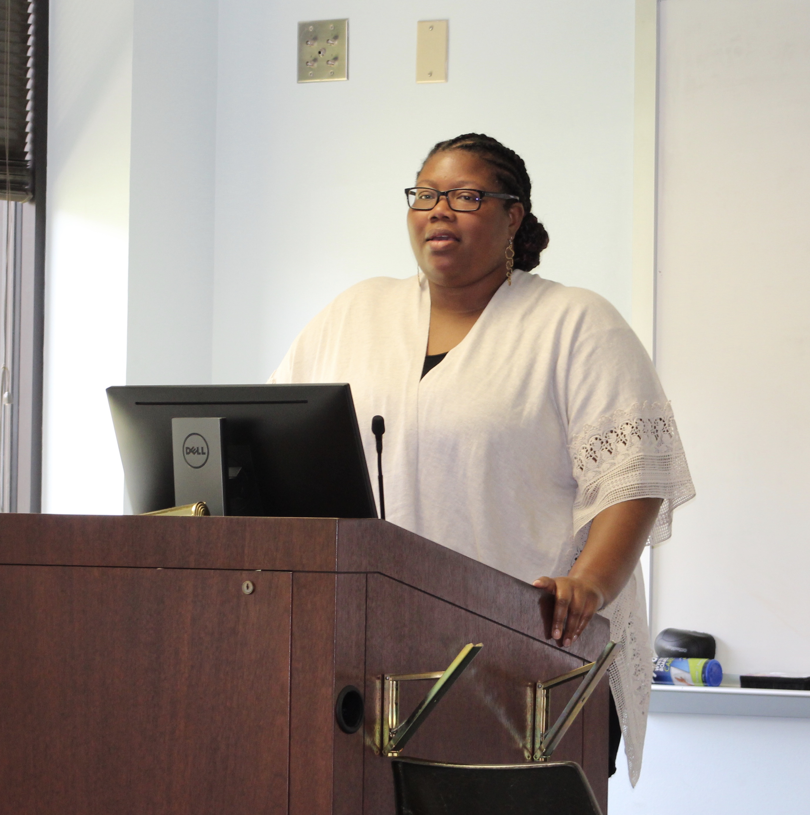 Female professor speaking at a podium